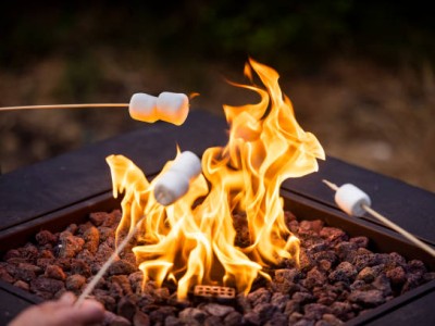 High quality stock photos of a family cooking s'mores over a fire pit.